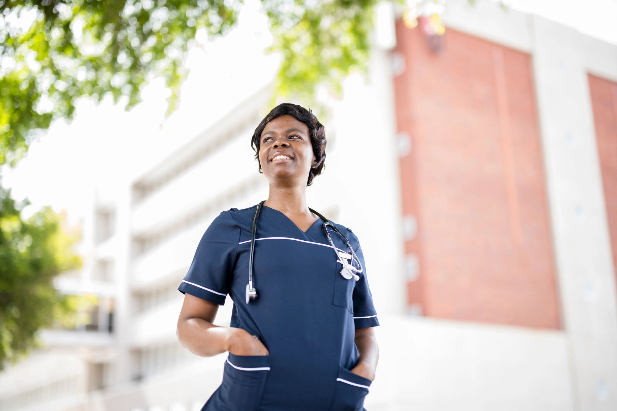 Travel nurse portrait outside hospital