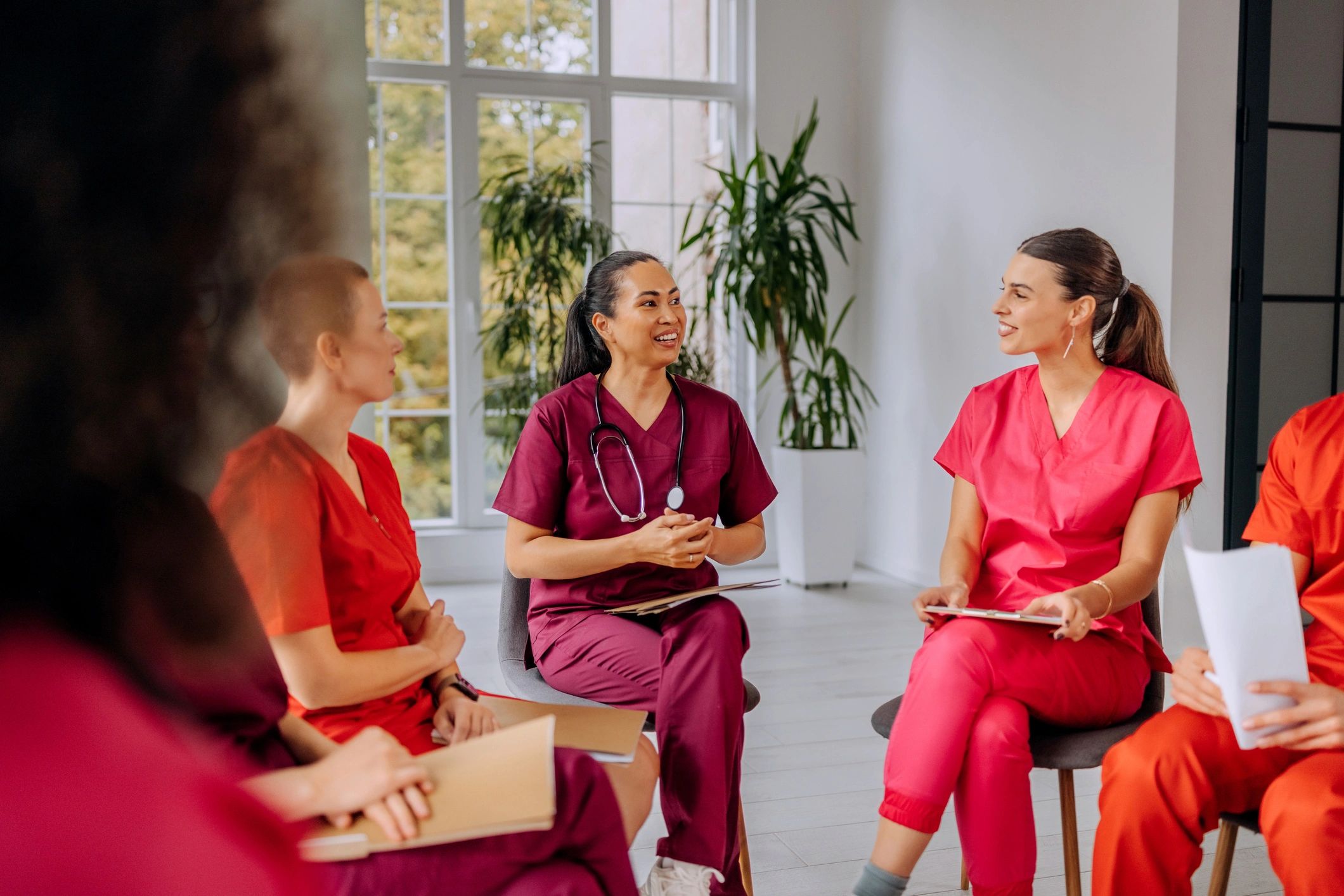 Professional female healthcare worker participating in a meeting with her medical team.